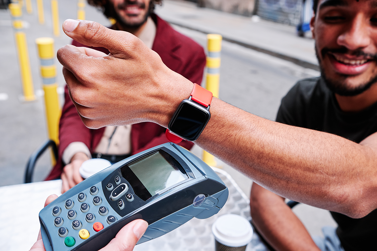Person paying on the go with a wearable