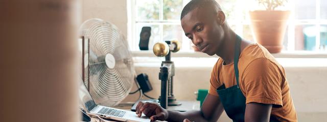 Man at desk with computer and paperwork