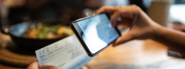 Person depositing or taking a picture of a cheque on a phone