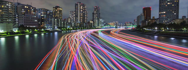 Colourful light trails in a city at dusk