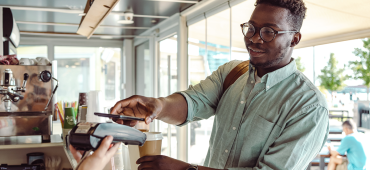 Man paying for coffee using a smartphone